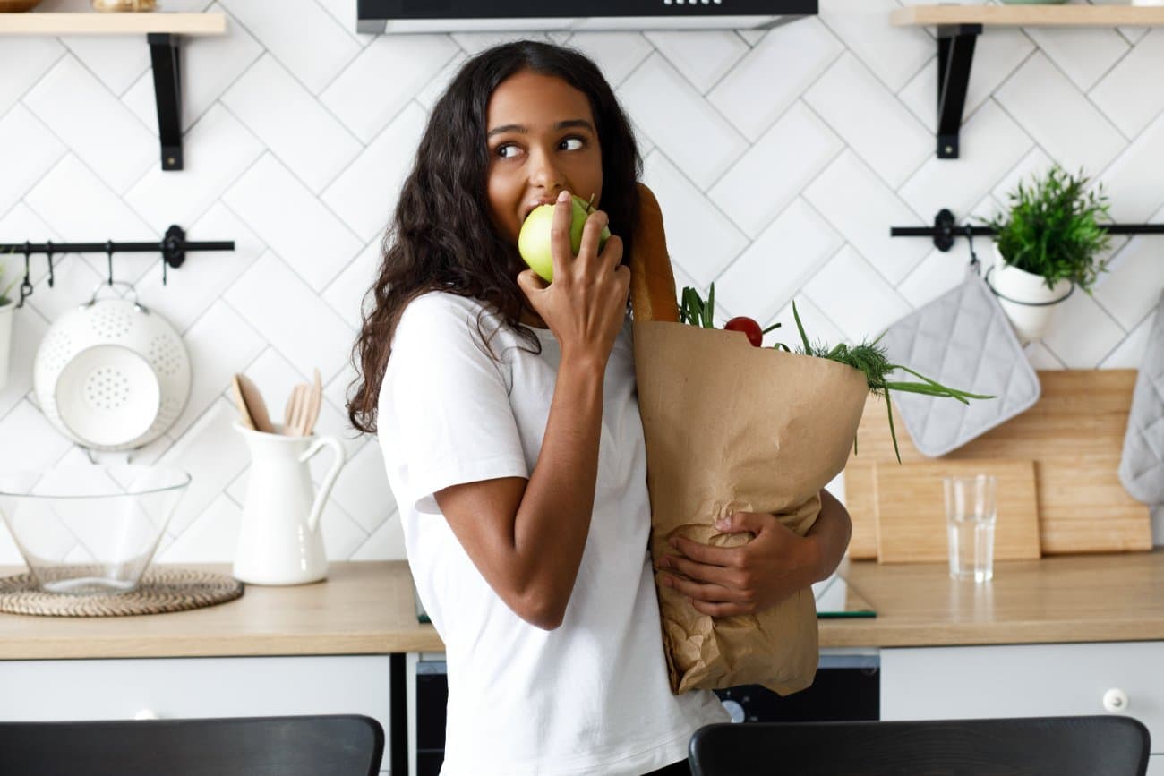A woman cooking with fresh produce in her own kitchen