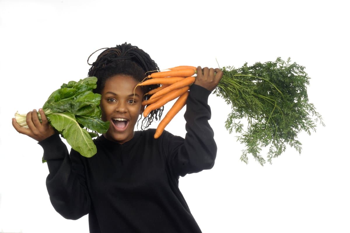 A woman enjoying fresh vegetables